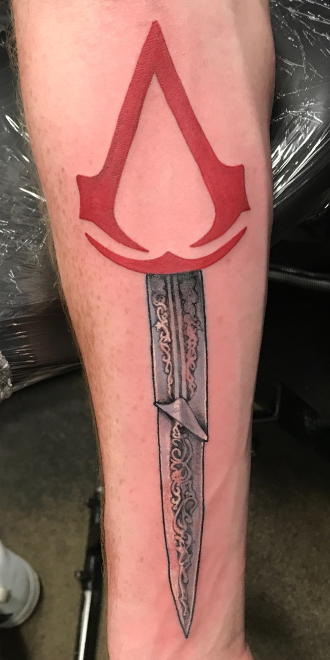 assassins creed tattoo, color tattoo, dagger tattoo, sword tattoo, Johnny calico, arm tattoo, tattoo artist Michigan